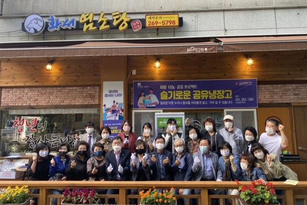 화서2동 관계자들이 공유냉장고가 설치된 화서염소탕 앞에서 기념사진을 찍고 있다.(사진=화서2동)