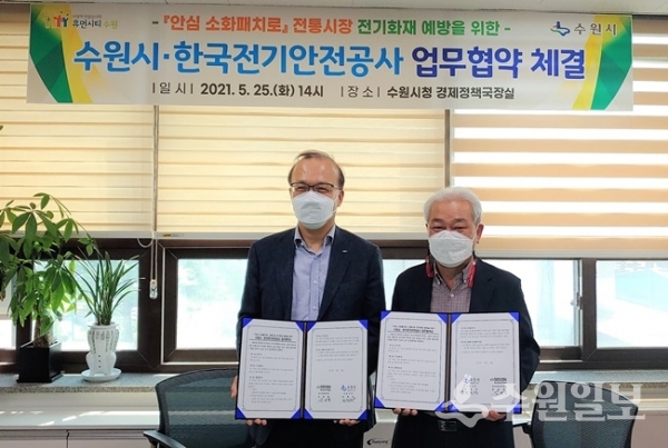 조진행 수원시 경제정책국장(오른쪽)과 강대철 한국전기안전공사 경기지역본부장이 업무협약을 체결한 뒤 기념촬영을 하고 있다. (사진=수원시)