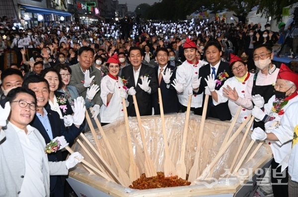 이재준 수원특례시장(오른쪽 7번째)을 비롯한 지역내빈, 관계자들이 수원 통닭거리에서 열린 ‘2022 수원 통닭거리 축제, 통닭에 빠지다’ 개막식에서 상인들과 함께 ‘닭강정 비빔 퍼포먼스’를 하고 있다. (사진=수원시)