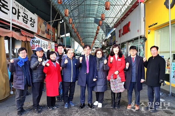 김학기 의왕시의회 의장(오른쪽에서 다섯번째)을 비롯한 시의원들이 전통시장인 도깨비시장을 찾아 지역상인들을 격려한 뒤 기념촬영을 하고 있다. (사진=의왕시의회)