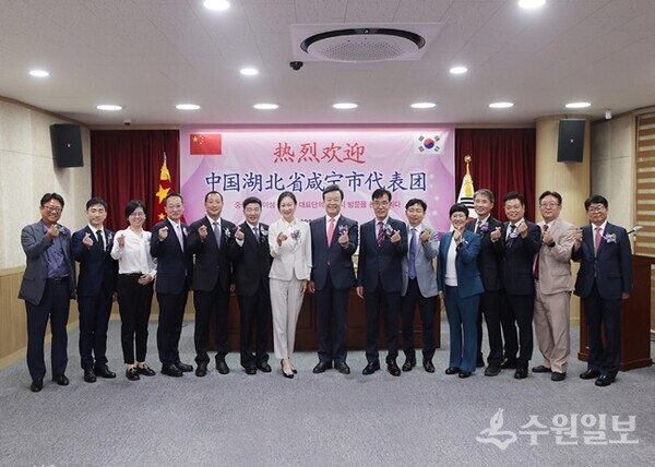 김성제 의왕시장(가운데)이 중국 셴닝시와 우호협력교류 협약식을 가진 뒤 양 기관 관계자들과 기념촬영을 하고 있다. (사진=의왕시)
