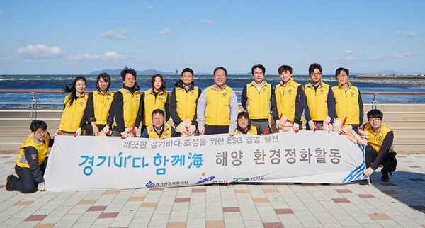 경기신보 임직원들이 지난 20일 안산시 대부도 해안가를 찾아 환경정화 캠페인을 벌인 뒤 기념촬영을 하고 있다.(사진=경기신보)