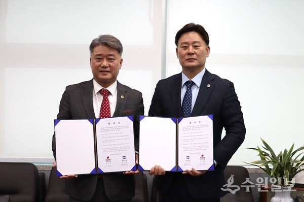 경기도의회 최종현 민주당 대표의원(오른쪽)과 김정호 국민의힘 대표의원이 합의문에 서명한 뒤 기념촬영을 하고 있다. (사진=경기도의회)