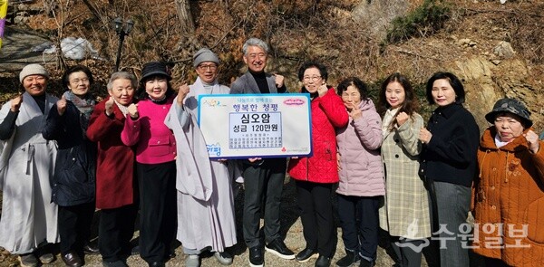 김수종 심오암 주지스님(왼쪽 5번째)이 조두영 가평군 청평면장(가운데)에게 성금을 기탁한 뒤 신도들과 함께 기념촬영을 하고 있다. (사진=가평군 청평면)