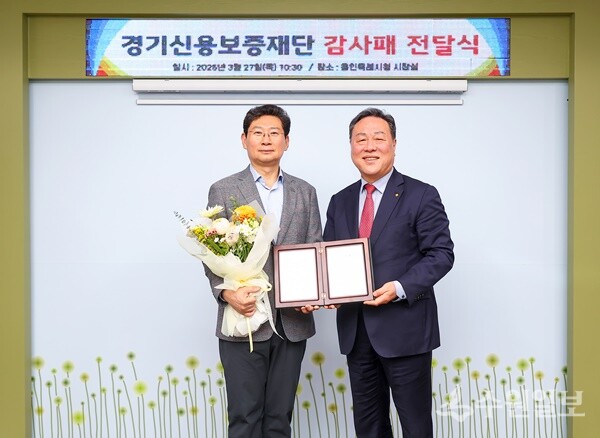 시석중 경기신용보증재단 이사장(오른쪽)이 27일 이상일 용인특례시장에게 감사패를 전달한 뒤 기념촬영을 하고 있다. (사진=경기신보)