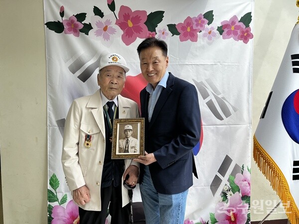 이계문 남양주도시공사 사장(오른쪽)이 신원식 6.25 참전 국가유공자회 남양주시지회장에게 AI 기술을 활용해 젊은 시절의 모습으로 변환한 사진을 액자에 담아 전달하고 있다. (사진=남양주도시공사)