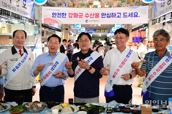 30일 외포항에서 가진 '안전한 강화군 수산물 소비촉진을 위한 간담회'가 끝난뒤 유정복 인천시장(왼쪽 두번째부터), 박용철 강화군수, 한승희 강화군의회 의장이 수산물 시식을 하고 있다. (사진=강화군)