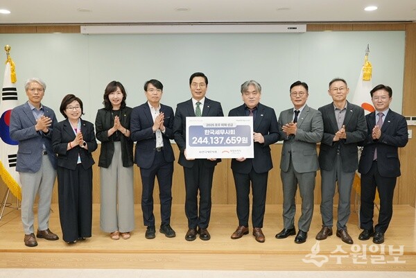 구재이 한국세무사회장(가운데)이 임채청 희망브리지 전국재해구호협회장(오른쪽 네번째)에게 수재의연금을 전달한 뒤 관계자들과 함께 기념촬영을 하고 있다. (사진=한국세무사회)
