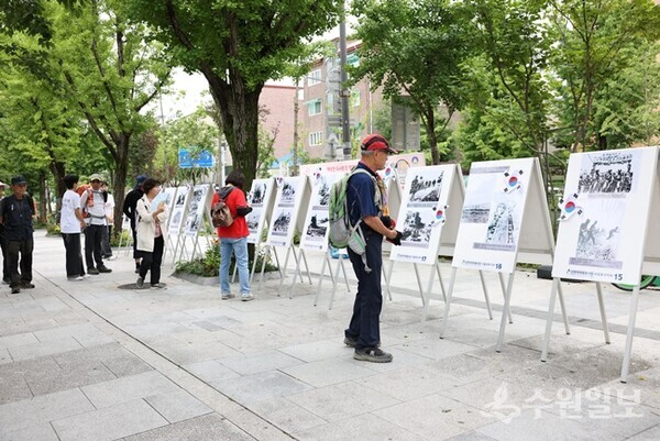 도봉산 입구에서 열린 ‘나라사랑 평화나눔’ 행사에 참여한 시민들이 사진전을 관람하고 있다. (사진=신천지자원봉사단 서울동부지부)