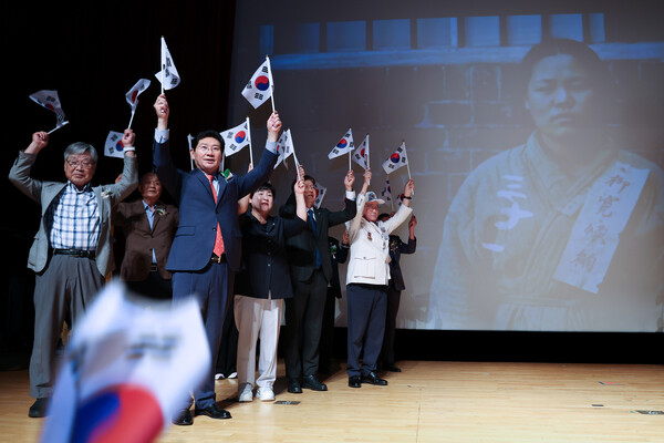 이상일 용인시장이 광복절 경축식에서 참석자들과 함께  태극기를 들어 보이고 있다 (용인시 제공)